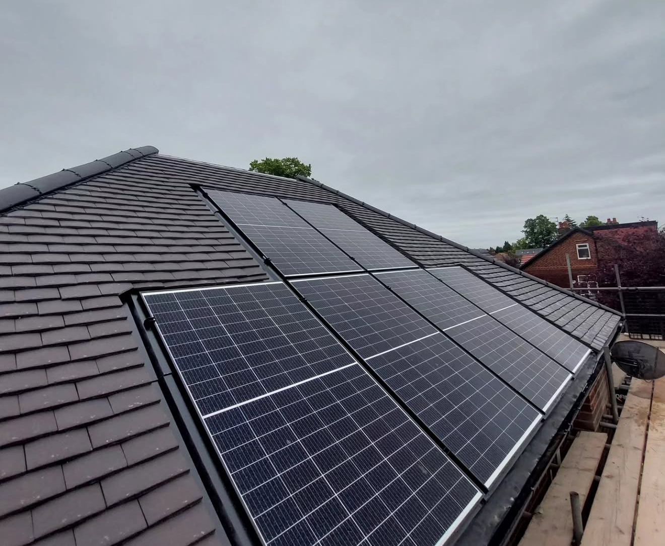 Slate roof with integrated solar panels and lead-dressed detailing